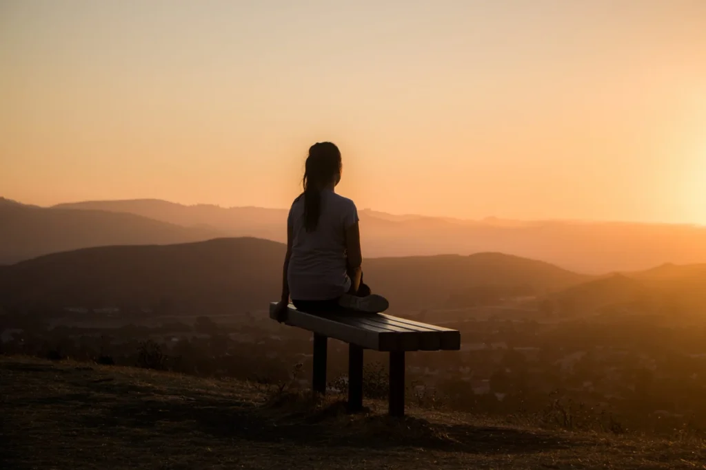 Women meditating at sunset