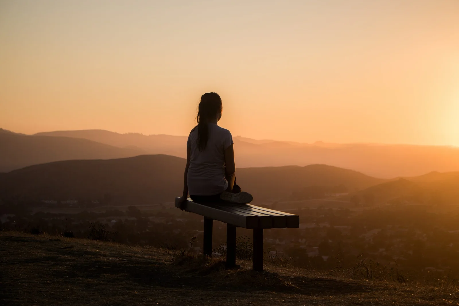 Women meditating at sunset